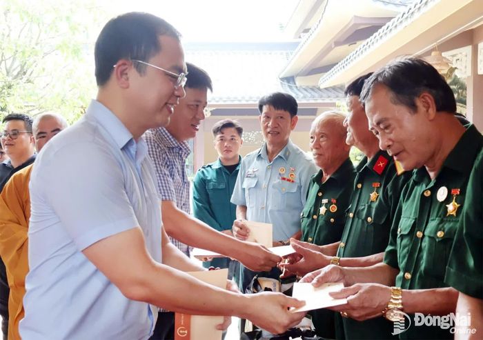 Đại tướng, Anh hùng lực lượng vũ trang nhân dân Phạm Văn Trà và Phó Bí thư Đảng ủy, Chủ tịch phường Long Thành Lê Hoàng Sơn tặng quà các cựu chiến binh. Ảnh: Nguyệt Hà