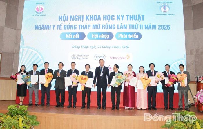 Tiến sĩ, Bác sĩ Nguyễn Văn Dương, Giám đốc Sở Y tế tỉnh Đồng Tháp (thứ 7 từ trái sang) và Bác sĩ chuyên khoa II Tạ Tùng Lâm, Giám đốc Bệnh viện Đa khoa Đồng Tháp trao Giấy chứng nhận và tặng hoa cho các chủ tọa Phiên hội nghị.