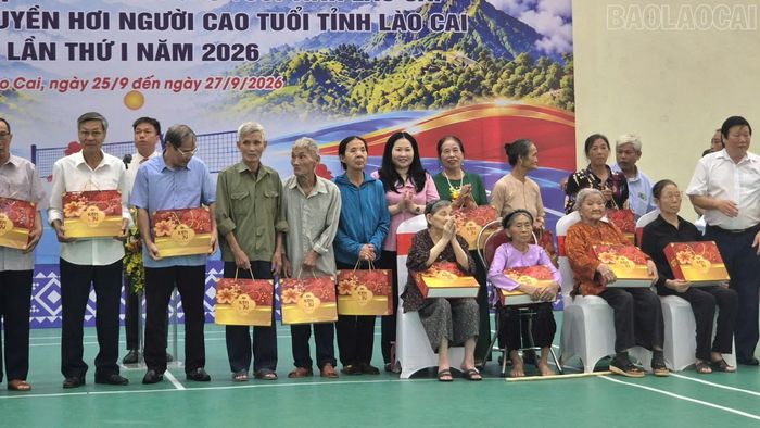 Ban tổ chức trao quà cho người cao tuổi có hoàn cảnh đặc biệt khó khăn.