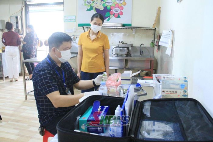 Test nhanh các mẫu thực phẩm tại bếp ăn trường học.