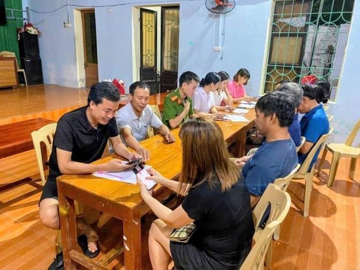 Đồng chí Lê Văn Sơn (ngoài cùng bên trái), Phó Bí thư Chi bộ thôn Hòa Bình, xã Hà Trung, tỉnh Thanh Hóa, cùng tổ công tác hướng dẫn đảng viên và người dân trong thôn sử dụng Sổ sức khỏe điện tử và thông tin bảo hiểm y tế trên điện thoại thông minh.