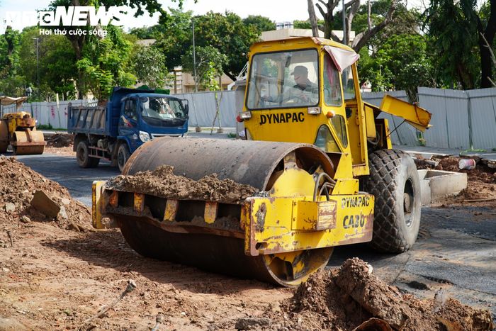 Trên công trường, nhiều công nhân cùng máy móc, thiết bị như xe cẩu, xe lu được huy động, khẩn trương triển khai các hạng mục nhằm bảo đảm tiến độ dự án.