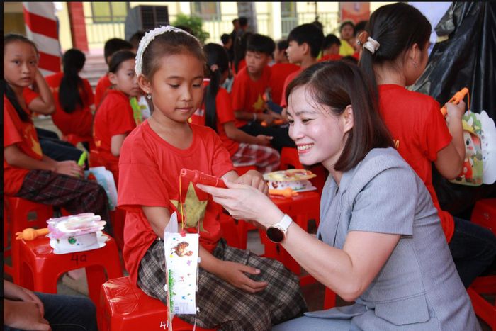 Bà Nguyễn Thị Hiền trao quà Trung thu cho trẻ. Ảnh: Vương Long