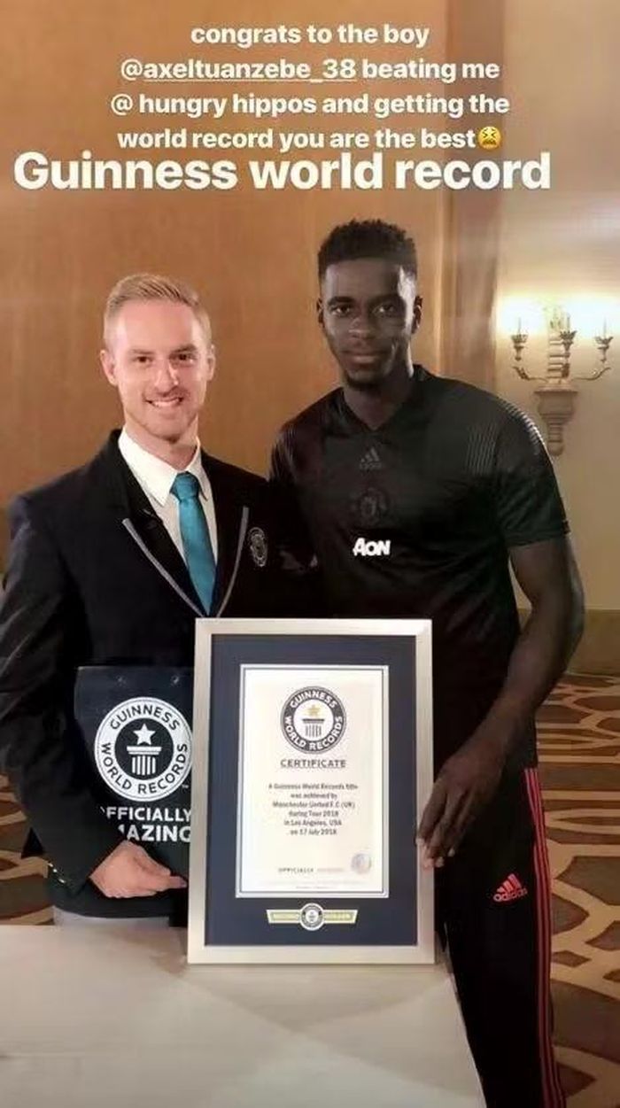 Hậu vệ Axel Tuanzebe nhận chứng nhận Guinness sau khi lập kỷ lục hoàn thành trò Hungry Hungry Hippos trong 17,36 giây. Ảnh: Instagram.