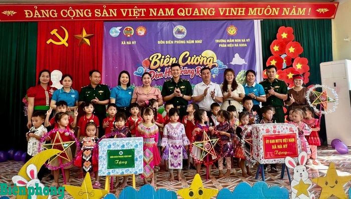 Đại diện Đồn Biên phòng Nậm Nhừ, cấp ủy, chính quyền xã Nà Hỳ, Trường Mầm non Nà Hỳ trao quà cho các em nhỏ. Ảnh: Chiến Khu