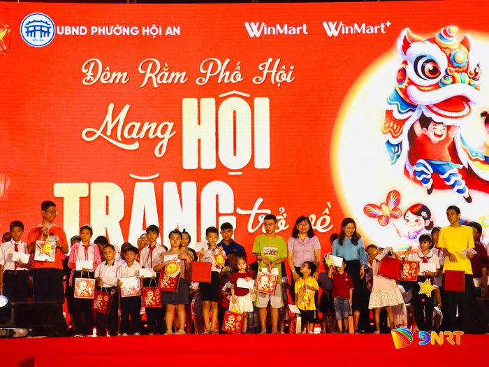Ban tổ chức tặng quà trung thu cho trẻ em phường Hội An. Ảnh: QUỐC TUẤN