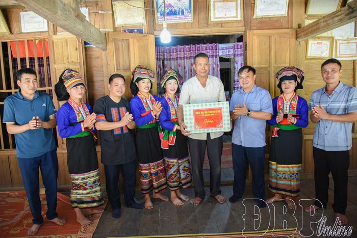 Ông Đặng Văn Tuấn, Chủ tịch UBND xã Mường Nhà (thứ 3 từ phải sang) cùng đại diện các phòng chức năng tặng quà chúc Tết người dân.