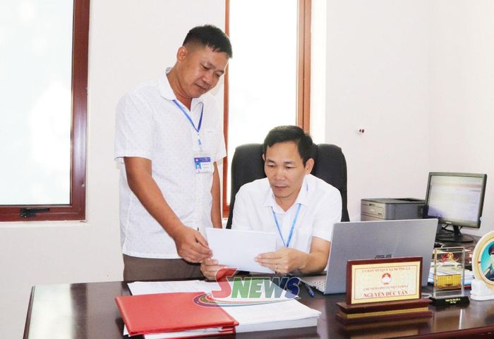 Ông Nguyễn Đức Vần, Chủ tịch Ủy ban MTTQ Việt Nam xã Mường La trao đổi công việc với cán bộ làm công tác chuyên môn.