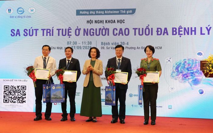 Thứ trưởng Bộ Y tế Nguyễn Thị Liên Hương tặng hoa chúc mừng đoàn chủ tọa hội nghị.