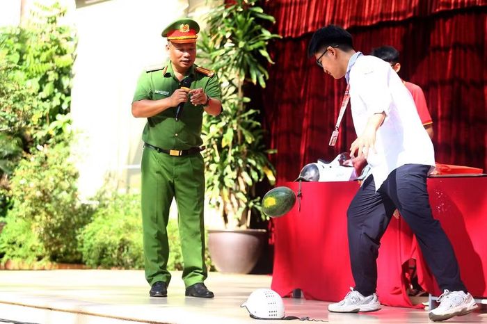 Cán bộ tuyên truyền chỉ rõ những nguy cơ chấn thương nguy hiểm khi sử dụng mũ bảo hiểm không đạt chuẩn nếu xảy ra va chạm giao thông