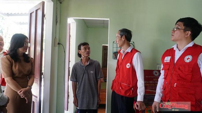 Ông Nguyễn Luận (thứ 3, từ phải sang) phấn khởi giới thiệu về ngôi nhà mới của mình vừa được sửa chữa khang trang, kiên cố