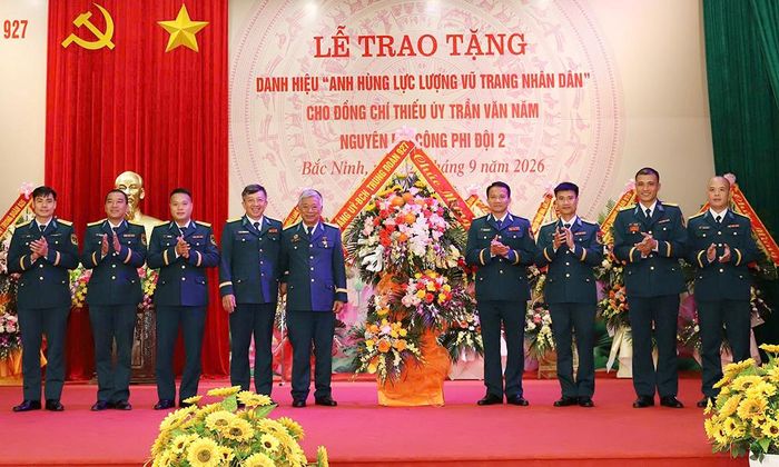  Các đồng chí lãnh đạo Trung đoàn 927 tặng hoa chúc mừng Anh hùng Lực lượng vũ trang nhân dân Trần Văn Năm. 