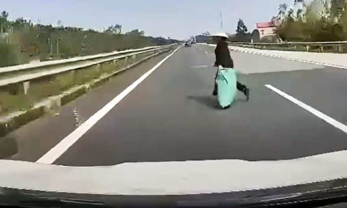 Người phụ nữ băng qua cao tốc khiến tài xế không kịp trở tay. (Ảnh: Chụp màn hình)