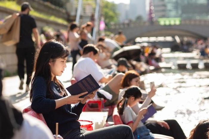 Nhiều người trẻ Hàn Quốc coi việc đọc sách ngoài trời là một xu hướng sành điệu trong thời đại công nghệ số. Ảnh: Chính quyền Seoul.