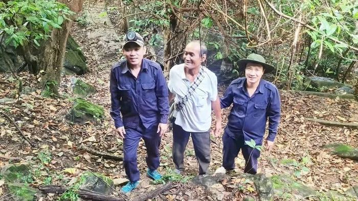 Ông Khăm Vả Xì Chăm Pa ở bản Thặm, xã Na Xể, huyện Thà Khẹc dẫn lực lượng tìm kiếm đến khu vực hang đá trên địa bàn có bộ đội Việt Nam hy sinh. (Ảnh: HC)