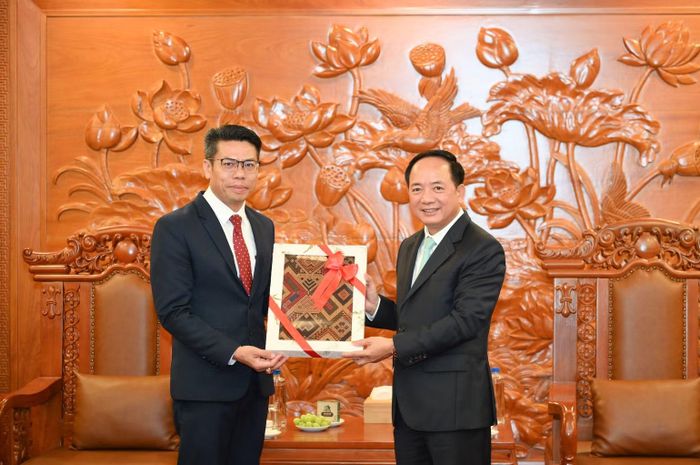 Đồng chí Sả Khon Phôm Mạ Lạt trao quà tặng đồng chí Trịnh Văn Quyết. (Ảnh: THẾ ĐẠI)