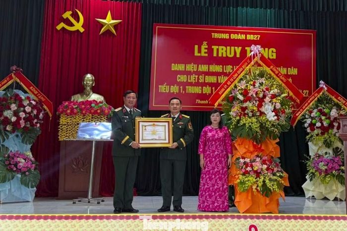 Thiếu tướng Nguyễn Thanh Tình, Phó Chính ủy Quân đoàn 12, trao danh hiệu Anh hùng Lực lượng vũ trang nhân dân đến gia đình liệt sĩ Đinh Văn Kiên.