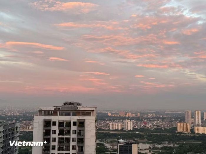 Hào quang trên bầu trời Hà Nội buổi bình minh gọi thành phố thức dậy. (Ảnh: Thái Hà/Vietnam+)