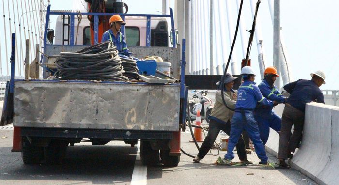 Theo ghi nhận của PV, trên cầu Phước Khánh, không khí thi công vẫn khẩn trương. Từng tốp công nhân tiếp tục dọn dẹp công trường, hoàn thiện các hạng mục an toàn giao thông và xử lý những chi tiết cuối trên mặt cầu.