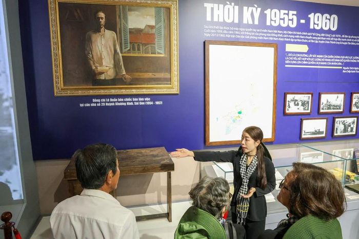 Hướng dẫn viên giới thiệu đến khách tham quan các hiện vật, tư liệu lịch sử quý tại nhà trưng bày Căn cứ Trung ương Cục miền Nam đến khách tham quan. Ảnh: Giang Phương - TTXVN