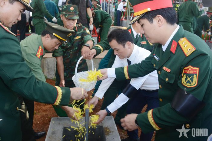 Lãnh đạo tỉnh Lào Cai và các đại biểu thả hoa xuống các phần mộ, nơi yên nghỉ của các liệt sĩ.