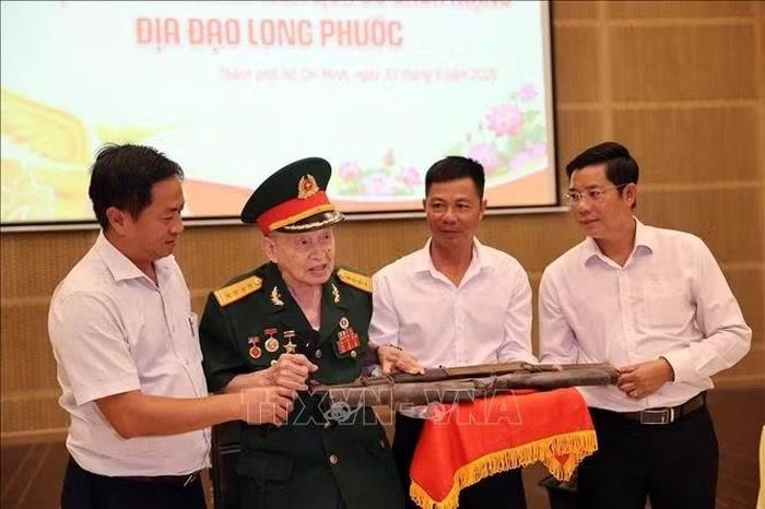 Anh hùng LLVTND, Đại tá Nguyễn Văn Tàu (bí danh Tư Cang, nguyên Cụm trưởng Cụm tình báo H63 huyền thoại) trao tặng 2 khẩu súng.