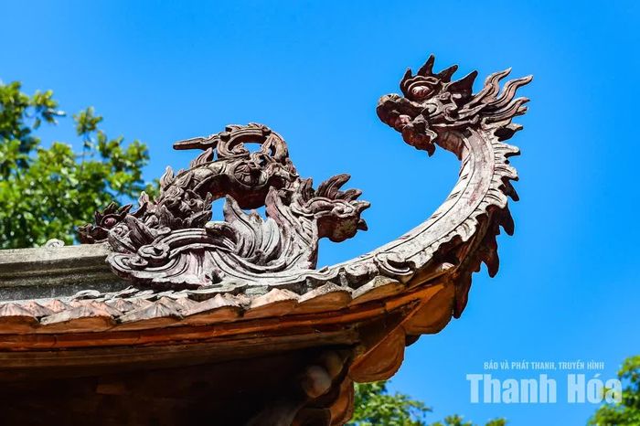 Phần mái có độ cong, tạo dáng vẻ đặc trưng thường thấy ở các công trình đình, chùa truyền thống. Họa tiết rồng được chạm khắc trên mái, mang đậm dấu ấn kiến trúc truyền thống của ngôi đền cổ.