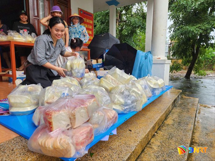 Lực lượng quân dân chính tổ dân phố Bích Hà (phường Điện Bàn Bắc) hỗ trợ thực phẩm cho người dân khu vực cô lập do ngập lụt tháng 10/2025. Ảnh: NGỌC QUỐC