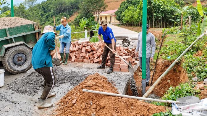 Người dân thôn Bến Đền chung sức xây dựng đường điện thắp sáng, góp phần để diện mạo quê hương ngày càng khởi sắc.