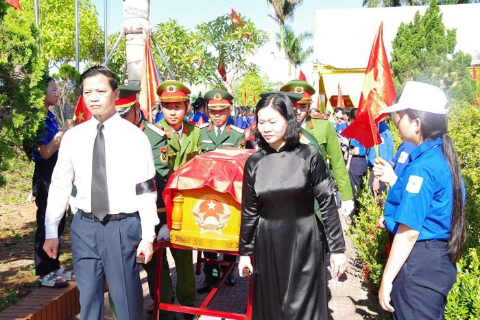 Các vị lãnh đạo, đại biểu thực hiện nghị thức di chuyển các hài cốt liệt sĩ ra khu vực an táng. (Ảnh: Xuân Diện - Hải Hoàng)