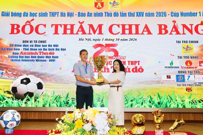 Bà Nguyễn Cẩm Phượng - Phó Giám đốc Đối ngoại và Quan hệ công chúng Tập đoàn Tân Hiệp Phát, Nhà tài trợ chính của giải và ông Vũ Mạnh Hùng, Phó trưởng Ban Biên tập An ninh Thủ đô cùng nâng cao chiếc cúp vô địch tượng trưng Giải bóng đá học sinh THPT Hà Nội - Báo An ninh Thủ đô lần thứ XXV năm 2026 - Cúp Number 1 Active