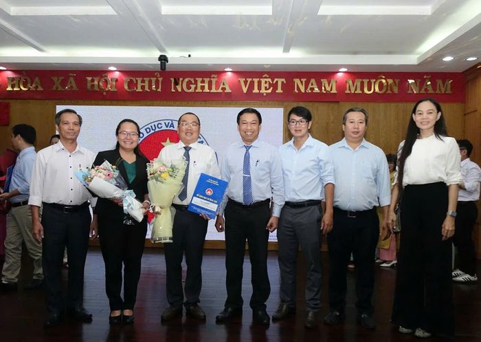  Ban Giám hiệu và giáo viên Trường THPT Nguyễn Hữu Thọ chúc mừng tân Phó Hiệu trưởng Phạm Đăng Khoa vừa nhận quyết định. 