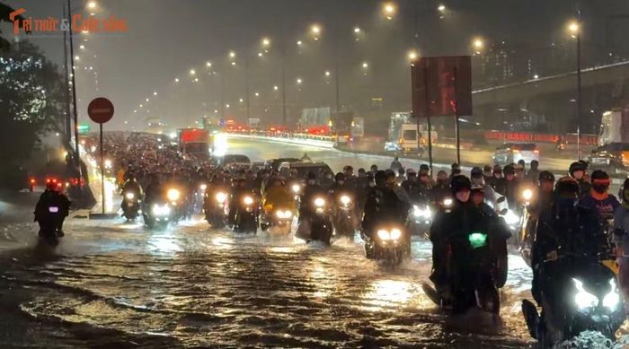 Lượng mưa cực lớn và kéo dài đã làm nước ngập lênh láng gần nửa bánh xe máy ngay tại dốc cầu Rạch Chiếc (hướng từ trung tâm thành phố đổ về Thủ Đức, thuộc phường Phước Long)