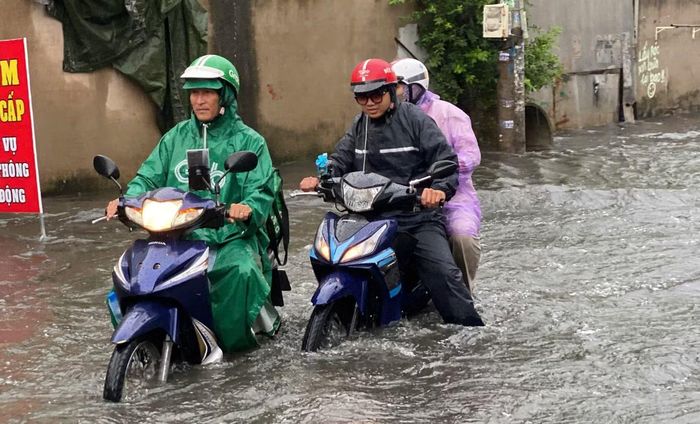 Người dân di chuyển trong cơn mưa lớn tại TPHCM