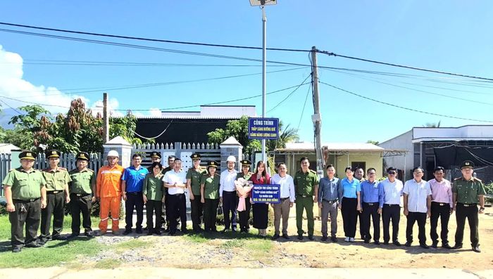 Lãnh đạo Công an tỉnh và đại diện Công ty cổ phần Điện lực Khánh Hòa bàn giao công trình “Thắp sáng đường quê bằng năng lượng xanh” tại thôn Suối Sim.