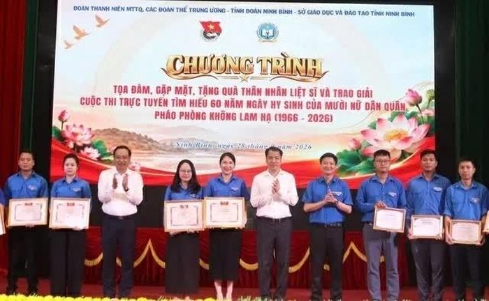  Ông Ngô Văn Cương và ông Đặng Thanh Sơn trao giải thưởng Cuộc thi trực tuyến “Tìm hiểu 60 năm ngày hy sinh của 10 nữ dân quân pháo phòng không Lam Hạ”. (Xuân Anh) 