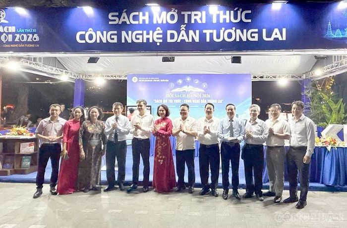 Bà Vũ Thu Hà (áo dài đỏ giữa ảnh) cùng các đại biểu chụp ảnh kỷ niệm. Ảnh Diệu Linh