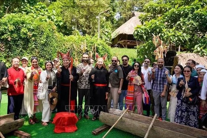 Đoàn đại biểu quốc tế chụp ảnh lưu niệm tại Làng Văn hóa - Du lịch các dân tộc Việt Nam. Ảnh: Khánh Hoà/TTXVN