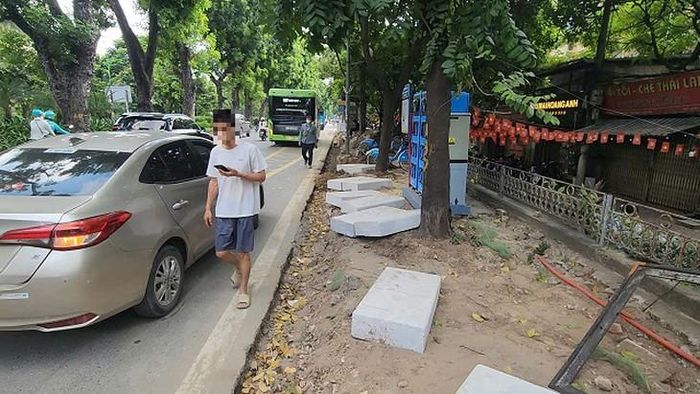 Việc thi công vỉa hè khiến người đi bộ phải đi dưới lòng đường. Ảnh: VA.