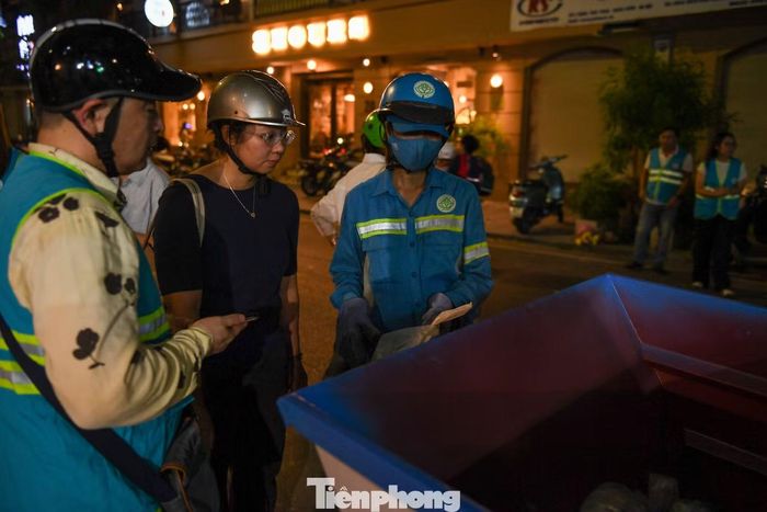 Trong ngày đầu, nhân viên URENCO phối hợp chính quyền phường Cửa Nam trực tiếp hướng dẫn, nhắc người dân phân loại đúng, sử dụng đúng túi và chuyển giao rác đúng thời gian.