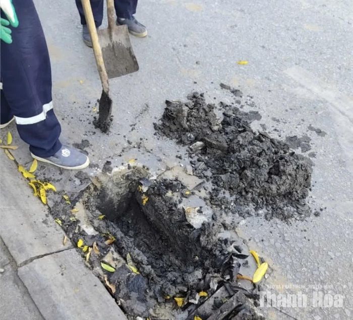 Miệng cống ngập bùn đất thải tại vị trí trên đường Trần Phú, phường Hạc Thành. (Ảnh chụp ngày 2/10)