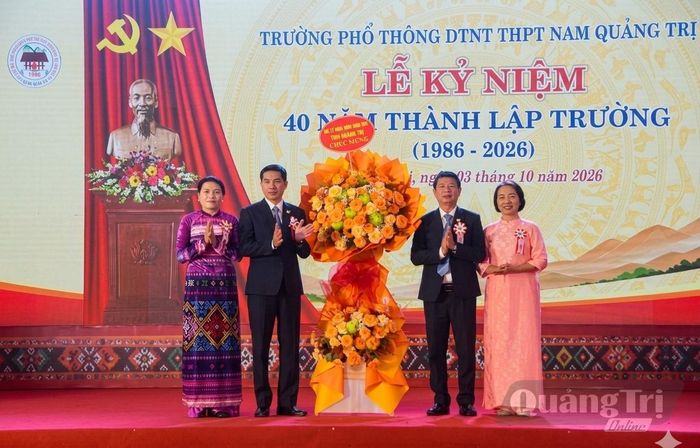 Đồng chí Ly Kiều Vân, Trưởng ban Nội chính Tỉnh ủy tặng hoa chúc mừng nhà trường - Ảnh: Đ.V