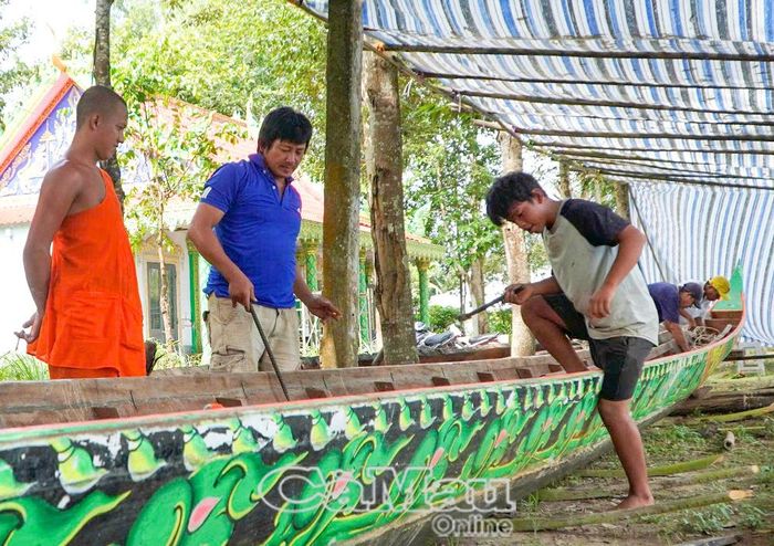 Các sư cùng người dân có kinh nghiệm chỉnh sửa lại ghe Ngo chuẩn bị cho giải đấu.