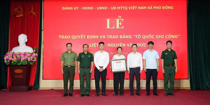 Lãnh đạo xã Phù Đổng trao Bằng “Tổ quốc ghi công” cho đại diện gia đình liệt sĩ Nguyễn Văn Đức. Ảnh: Sơn Nguyễn