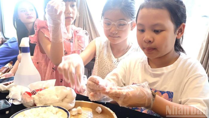Trên toa cộng đồng còn có hoạt động trải nghiệm làm các loại bánh, nhồi bột nấu chè dành cho trẻ. Các cháu rất thích làm, sau đó được thưởng thức tại chỗ sản phẩm của mình làm ra. (Ảnh: HG)