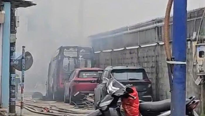 Hiện trường vụ cháy với chiếc ô tô 16 chỗ bị hư hỏng nặng. Ảnh: MK 
