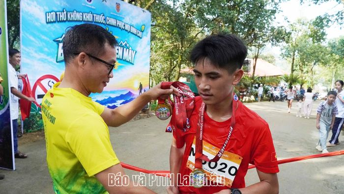 Lãnh đạo Báo Pháp luật Việt Nam trao huy  chương cho vận động viên đầu tiên về đích ở cự ly 5km.