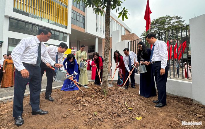 Các đại biểu tham gia trồng cây lưu niệm tại trường THCS Trung Hòa. Ảnh: Vân Nhi