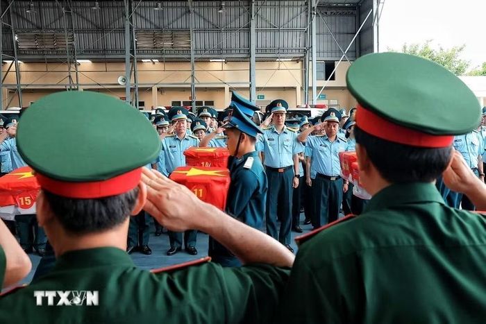 Cán bộ, chiến sỹ trang nghiêm thực hiện nghi thức tiếp nhận các thùng chứa mẫu sinh phẩm hài cốt liệt sỹ tại sân bay quân sự Gia Lâm, Hà Nội. (Ảnh: Phạm Tuấn Anh/TTXVN)