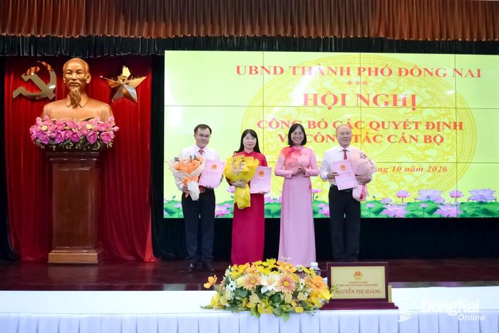 Thành ủy viên, Phó Chủ tịch UBND thành phố Nguyễn Thị Hoàng trao quyết định của Chủ tịch UBND thành phố và chúc mừng các đồng chí nhận quyết định công tác cán bộ. Ảnh: Phương Hằng
